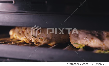 Delicious juicy meat steak cooking on the grill. Cook grilling fresh chicken breast. Fry chicken fillet on electric roaster. Slow motion. 75399776