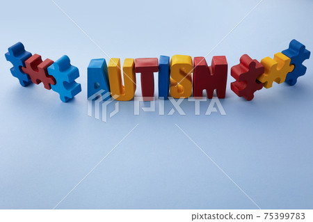 Autism awareness concept with puzzle and word autism on blue background. 75399783