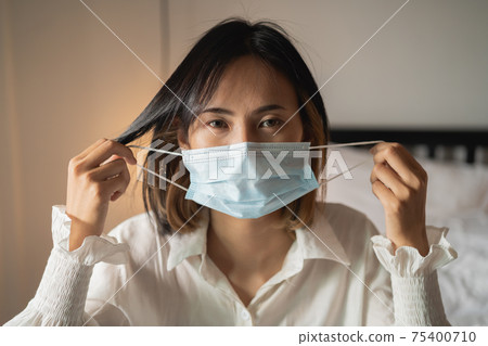close up women wearing surgical mask in the bedroom close up women wearing surgical mask in the bedroom 75400710