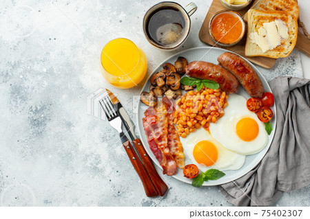 Full English breakfast on a plate with fried eggs 75402307