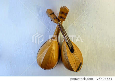 Lute - a stringed musical instrument with frets on the fretboard. Lute - a stringed musical instrument with frets on the fretboard. 75404334