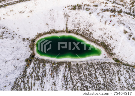 A lake formed on phosphogypsum waste, a tourist find in Ukraine, white mountains from phosphate waste. A lake formed on phosphogypsum waste, a tourist find in Ukraine, white mountains from phosphate waste. 75404517