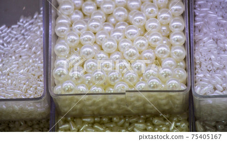 Pearl beads in different boxes as material for handmade jewelery Pearl beads in different boxes as material for handmade jewelery 75405167