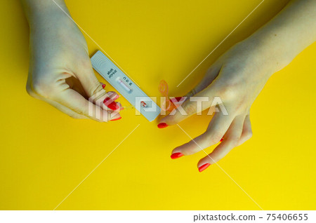 coronavirus test on a yellow, bright background. medical analysis. test strip for assessing the presence of IgG and IgM antibodies 75406655