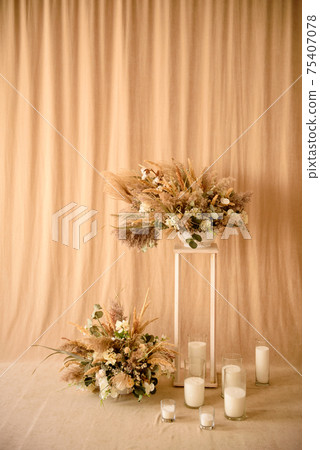 Decorations from dry beautiful flowers in a white vase on a beige fabric background 75407078