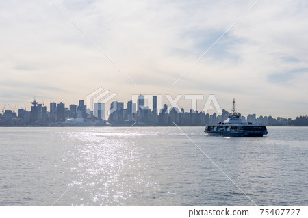 SeaBus ferry service and Vancouver city skyline in the background. 75407727