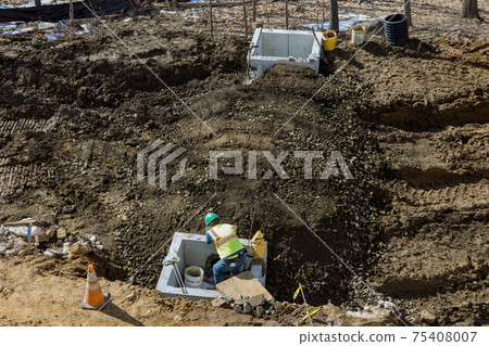 Installed construction of concrete pipe of drainage system work on the road for drained water sewer Installed construction of concrete pipe of drainage system work on the road for drained water sewer 75408007