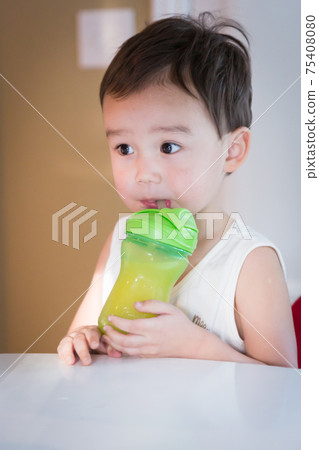 Cute Young Chinese and Caucasian Boy Enjoying Eating His Drink Cute Young Chinese and Caucasian Boy Enjoying Eating His Drink 75408080