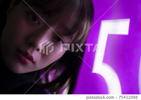 Woman illuminated by neon Woman illuminated by neon 75412098
