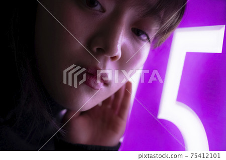 Woman illuminated by neon Woman illuminated by neon 75412101