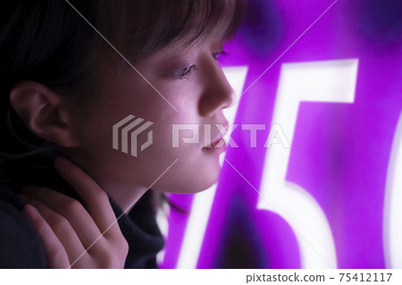 Woman illuminated by neon 75412117