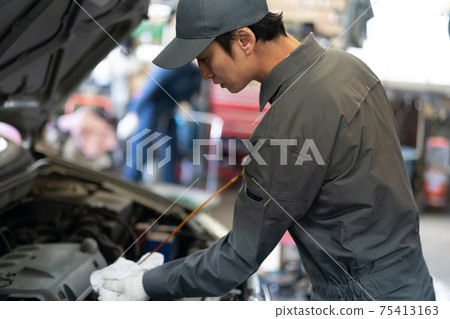 Auto mechanic working in a factory 75413163