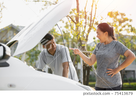 asian elderly husband and wife couples lose temper broken car have a problem on the road. asian elderly husband and wife couples lose temper broken car have a problem on the road. 75413679