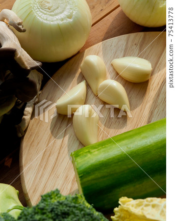 Fresh organic vegetables mushrooms, zucchini, garlic and green onions Fresh organic vegetables mushrooms, zucchini, garlic and green onions 75413778