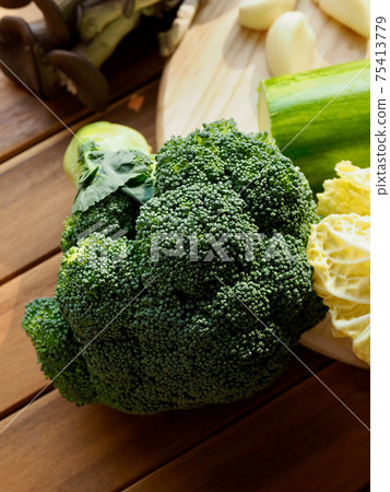 Fresh organic vegetables mushrooms, zucchini, garlic and green onions Fresh organic vegetables mushrooms, zucchini, garlic and green onions 75413779