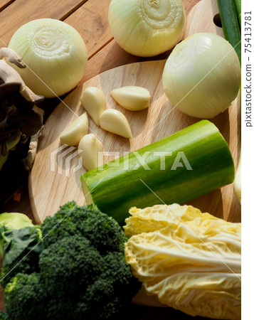Fresh organic vegetables mushrooms, zucchini, garlic and green onions Fresh organic vegetables mushrooms, zucchini, garlic and green onions 75413781