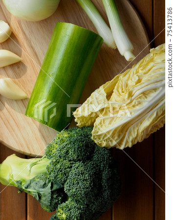 Fresh organic vegetables mushrooms, zucchini, garlic and green onions Fresh organic vegetables mushrooms, zucchini, garlic and green onions 75413786