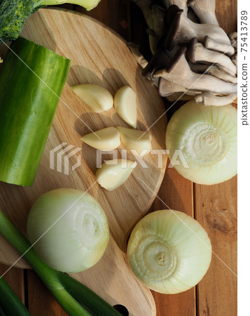 Fresh organic vegetables mushrooms, zucchini, garlic and green onions Fresh organic vegetables mushrooms, zucchini, garlic and green onions 75413789