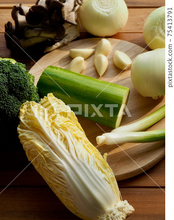 Fresh organic vegetables mushrooms, zucchini, garlic and green onions Fresh organic vegetables mushrooms, zucchini, garlic and green onions 75413791