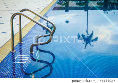 Swimming pool without people with metal handrails Swimming pool without people with metal handrails 75414087
