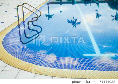 Swimming pool without people with metal handrails Swimming pool without people with metal handrails 75414088