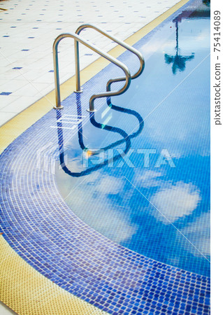 Swimming pool without people with metal handrails Swimming pool without people with metal handrails 75414089