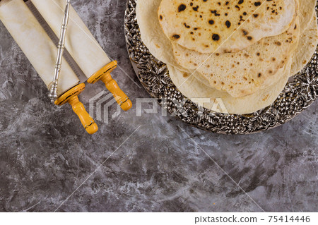 Jewish holiday passover with jewish unleavened bread matzah and torah 75414446
