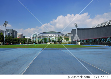 Sports field grass and urban building exterior 75415485