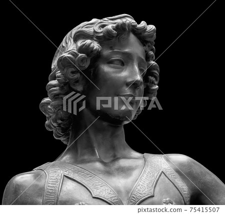 David killer of Goliath ancient statue. Biblical story. Antique sculpture of young man in armor isolated on black background 75415507