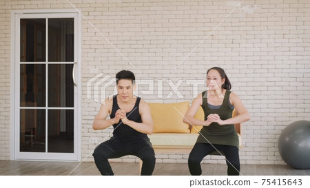 family couple doing YOGA standing meditating on exercise sitting squat family couple doing YOGA standing meditating on exercise sitting squat 75415643