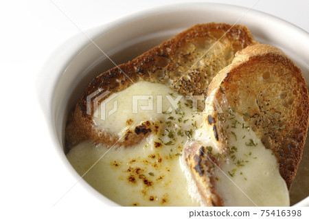 Photographed onion soup with charred cheese and French bread on a white background Photographed onion soup with charred cheese and French bread on a white background 75416398