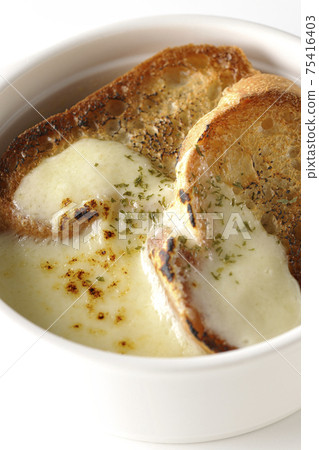 Photographed onion soup with charred cheese and French bread on a white background Photographed onion soup with charred cheese and French bread on a white background 75416403
