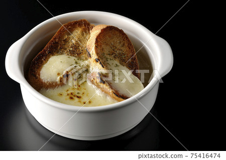 Photographed onion soup with charred cheese and French bread on a black background Photographed onion soup with charred cheese and French bread on a black background 75416474