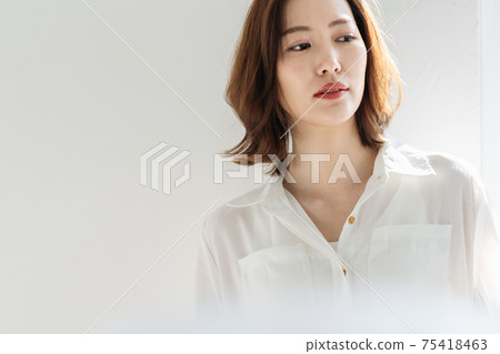Woman in a white shirt Woman in a white shirt 75418463