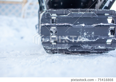 Rear suspension of a snowmobile in winter. Riding in the snow Rear suspension of a snowmobile in winter. Riding in the snow 75418808