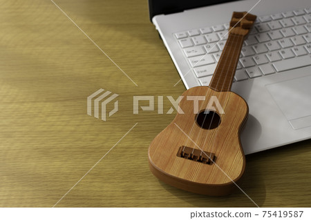 Image of practicing by looking at a computer. Laptop and toy guitar 75419587