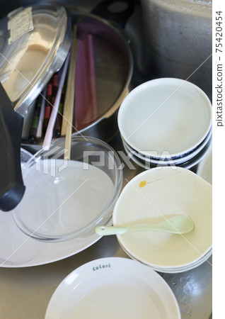 Unwashed dishes that have accumulated Unwashed dishes that have accumulated 75420454