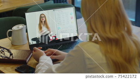 Young student watching lesson online and studying from home. Girl student studying from home. Distance learning, training video, online meeting, video call, webinar concept. 75422172