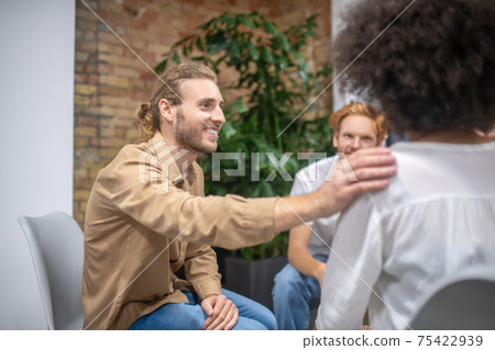 Group members supporting each other and looking friendly 75422939