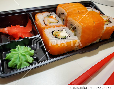 Food delivery in home delivery of sushi rolls, Japanese cuisine Food delivery in home delivery of sushi rolls, Japanese cuisine 75424968