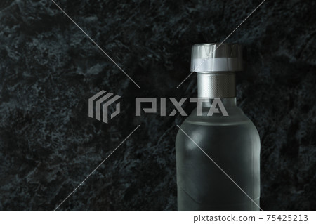 Blank bottle of vodka on black smokey background, space for text Blank bottle of vodka on black smokey background, space for text 75425213