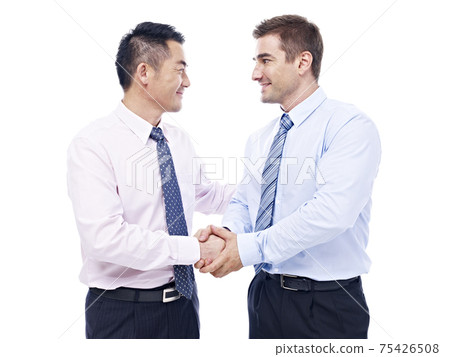 asian and caucasian businessmen shaking hands looking at each other, isolated on white background 75426508