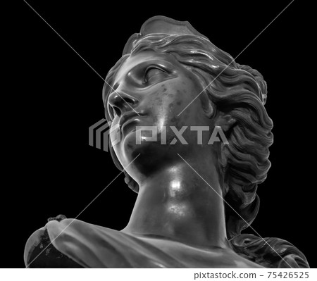Ancient white marble sculpture head of young woman. Statue of sensual renaissance art era woman antique style. Face isolated on black background Ancient white marble sculpture head of young woman. Statue of sensual renaissance art era woman antique style. Face isolated on black background 75426525