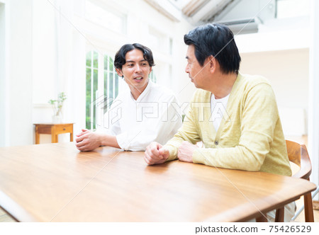 Parents and children talking in the living room Parents and children talking in the living room 75426529