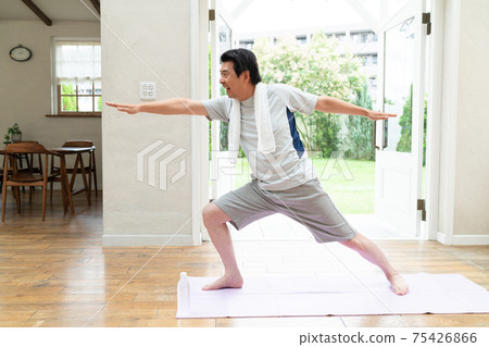 A man in his 60s enjoying yoga at home 75426866