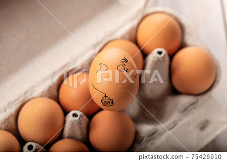 One egg stands out from crowd of other eggs. Concept of rejection, hostility, exclusion, exile 75426910