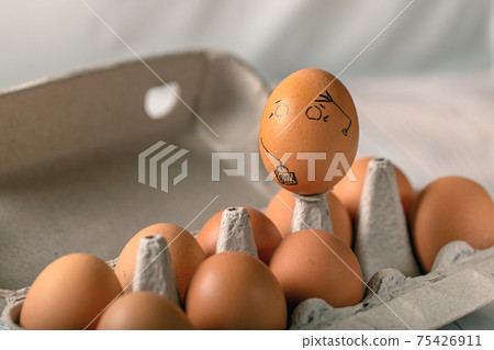 One pained egg standing apart from others eggs. concept of racism, intolerance, denial of society 75426911