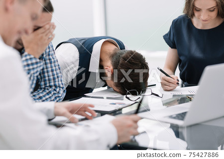 tired employee at a business meeting in the office 75427886