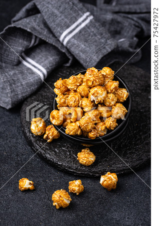Salted caramel popcorn in bowl Salted caramel popcorn in bowl 75427972