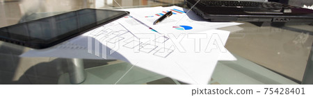 laptop and financial documents on a Desk in a spacious office laptop and financial documents on a Desk in a spacious office 75428401